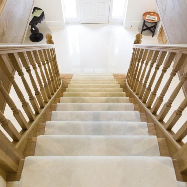 straight carpeted wooden staircase